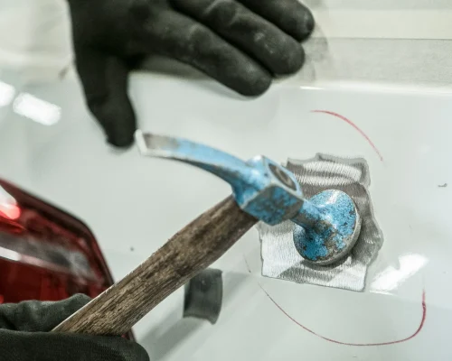 auto-repair-technician-fixing-dented-metal-panel-2026-01-07-00-30-44-utc