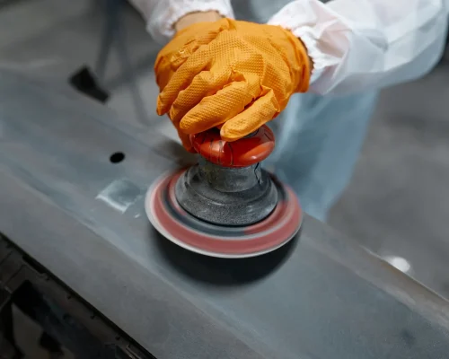 repair-work-orange-gloves-smoothing-the-car-bumpe-2026-03-17-03-35-38-utc